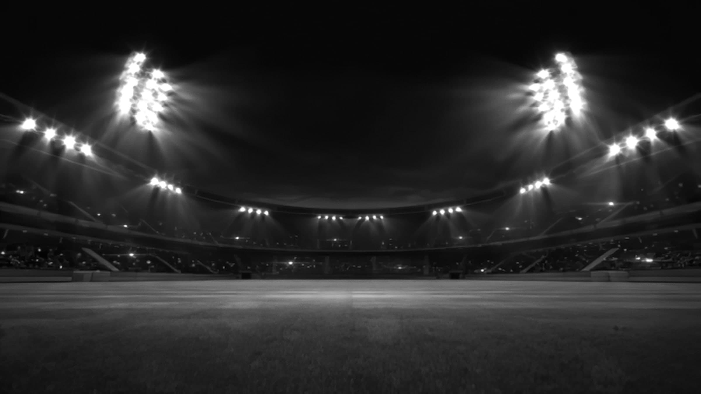 A floodlit stadium at night